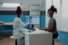 Medic holding radiography for examination with patient